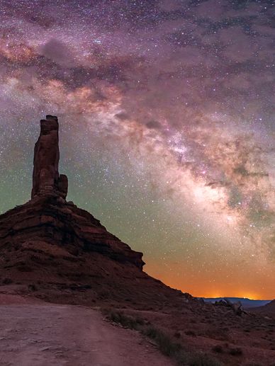 Milky Way over rock formation at dusk.