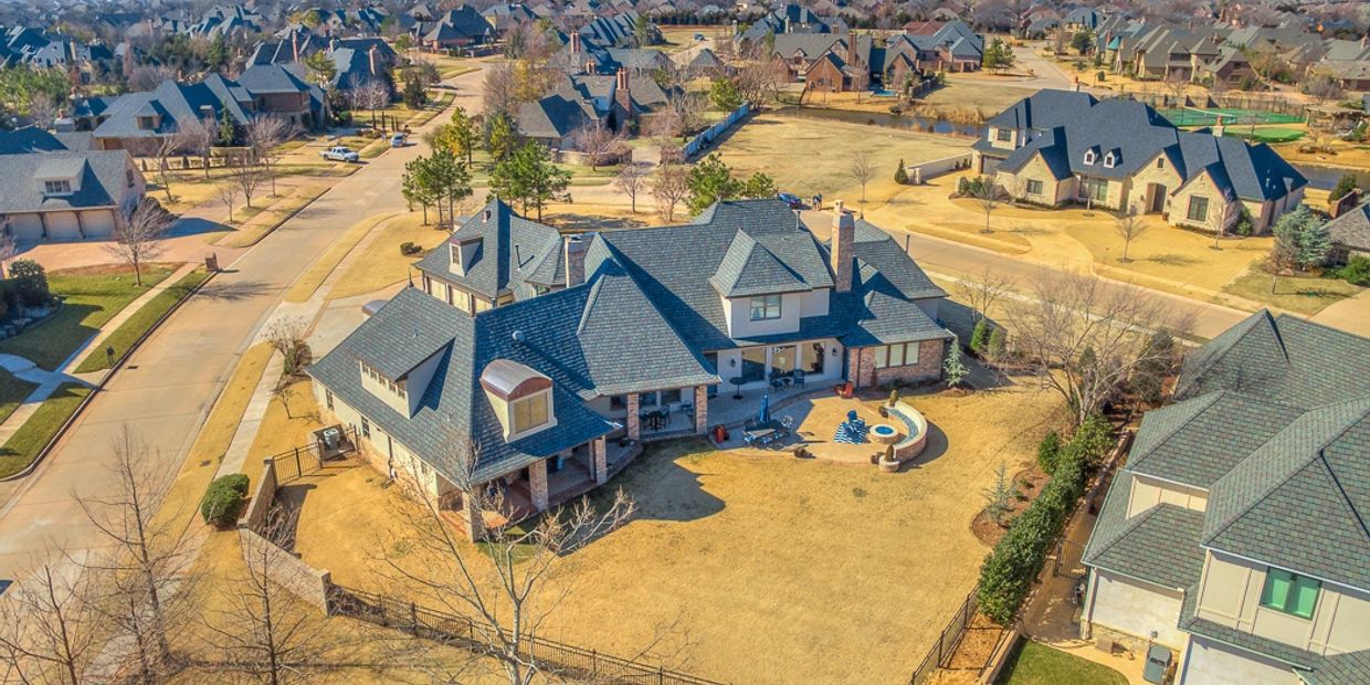 Aerial view of a suburban neighborhood with spacious houses and large yards.