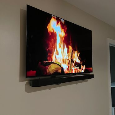 60" TV with soundbar mounted in drywall