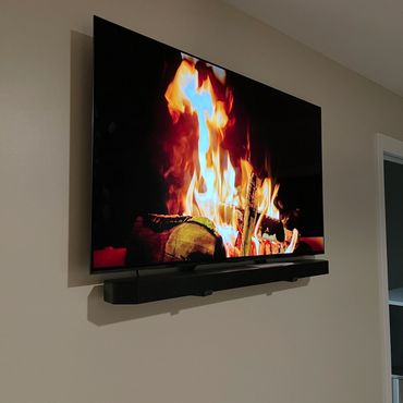 60" TV with soundbar mounted in drywall