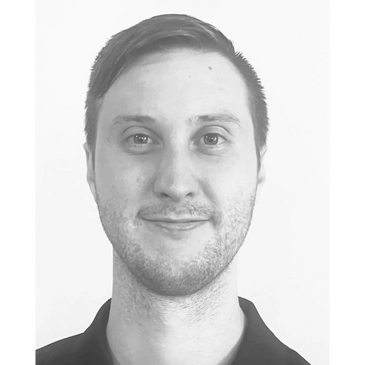 Smiling man in a black polo shirt with ADHD Solutions logo.