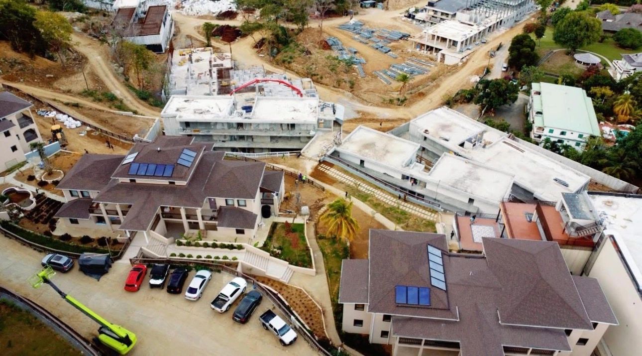 Aerial view of a residential area with large houses and ongoing construction.