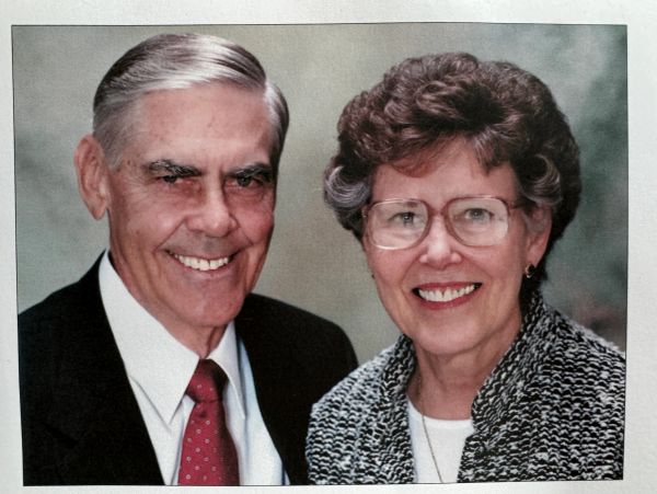 Smiling elderly couple posing for a formal portrait.