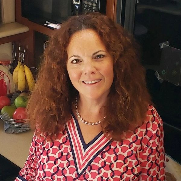 A woman with shoulder-length wavy hair