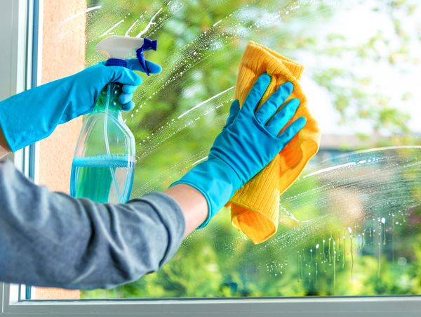 A person cleaning glass
