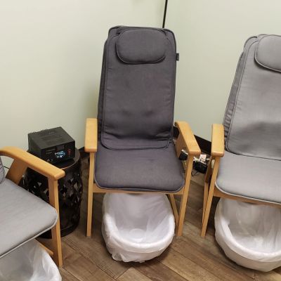 Pedicure chairs with foot baths in a salon.
