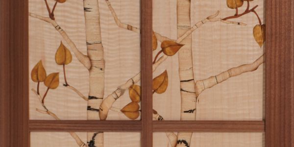 A panel of birch tree and leaves (of a veneer samples) is made into into a beautiful furniture.