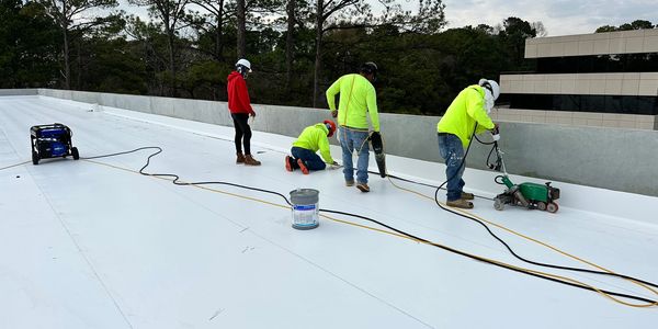 Heat welding tpo on a shopping center.
