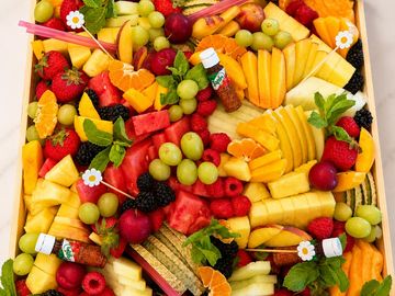 A bright and beautiful celebration of seasonal fresh fruit, artfully arranged with a colorful mix of