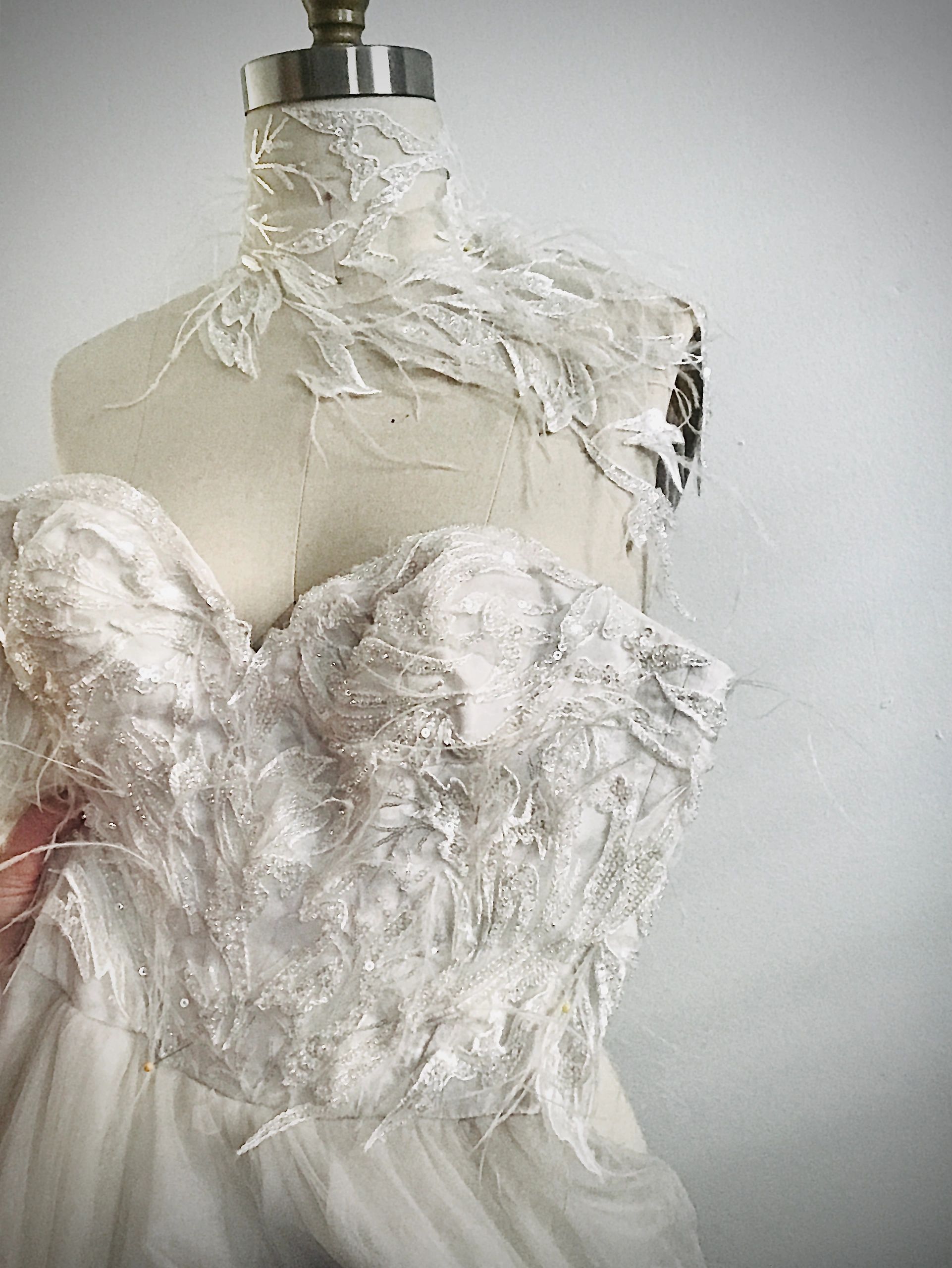 Intricate lace wedding dress bodice on a mannequin.