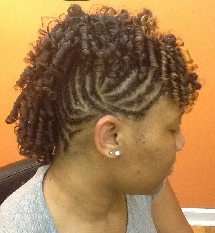 Curled hairstyle with intricate side cornrows.
