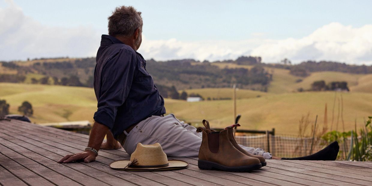 Man on his verandah looking across the countryside in the morning light