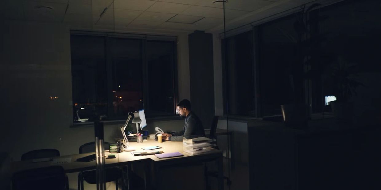 Man working late at night at his office under Stress