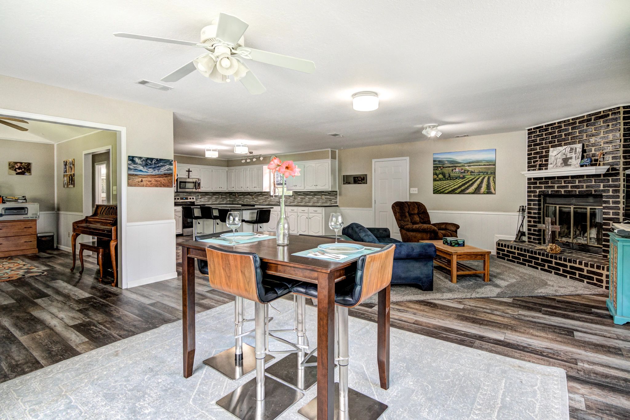Cozy open-plan living room and kitchen with dining area.