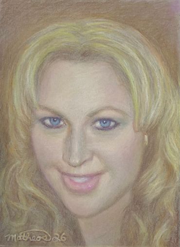 Portrait of a blonde woman with blue eyes and a gentle smile.