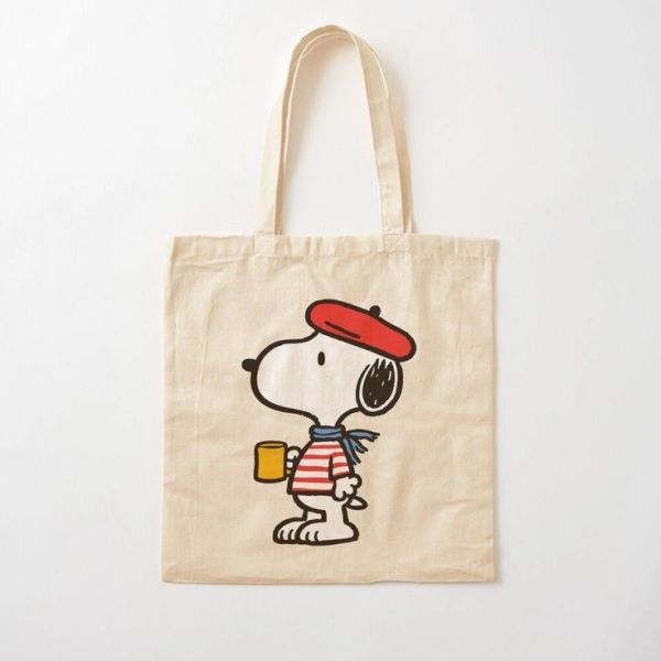 Canvas tote bag featuring Snoopy with a red beret and striped shirt.