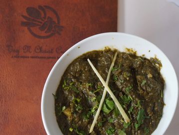 A bowl of Aloo Palak on a menu