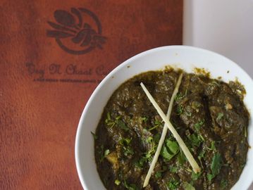 An Aloo Palak bowl on a menu