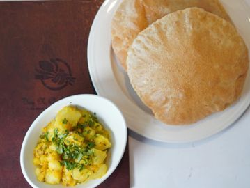 A Poori Bhaji with a side dish