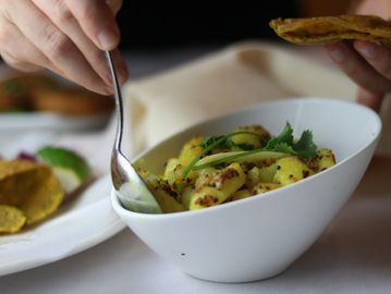 A spoon dipping into the bowl of food