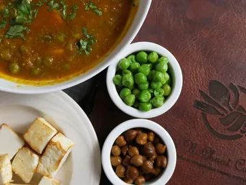 Small bowls of sides with beans and seeds