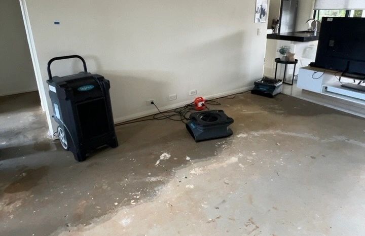 Flood damaged living room with drying equipment in use. Flood damaged living room with drying equipment in use.
