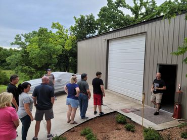 cowed of people about to enter a barn