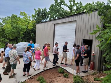 crowd of people entering a barn