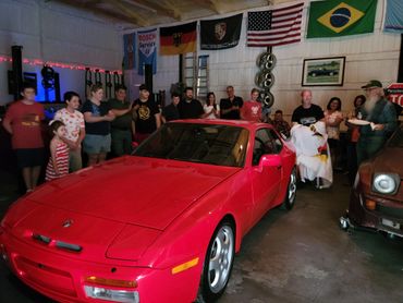 the flag has been completely removed and the 1986 Red Porsche 944 Turbo is reveled