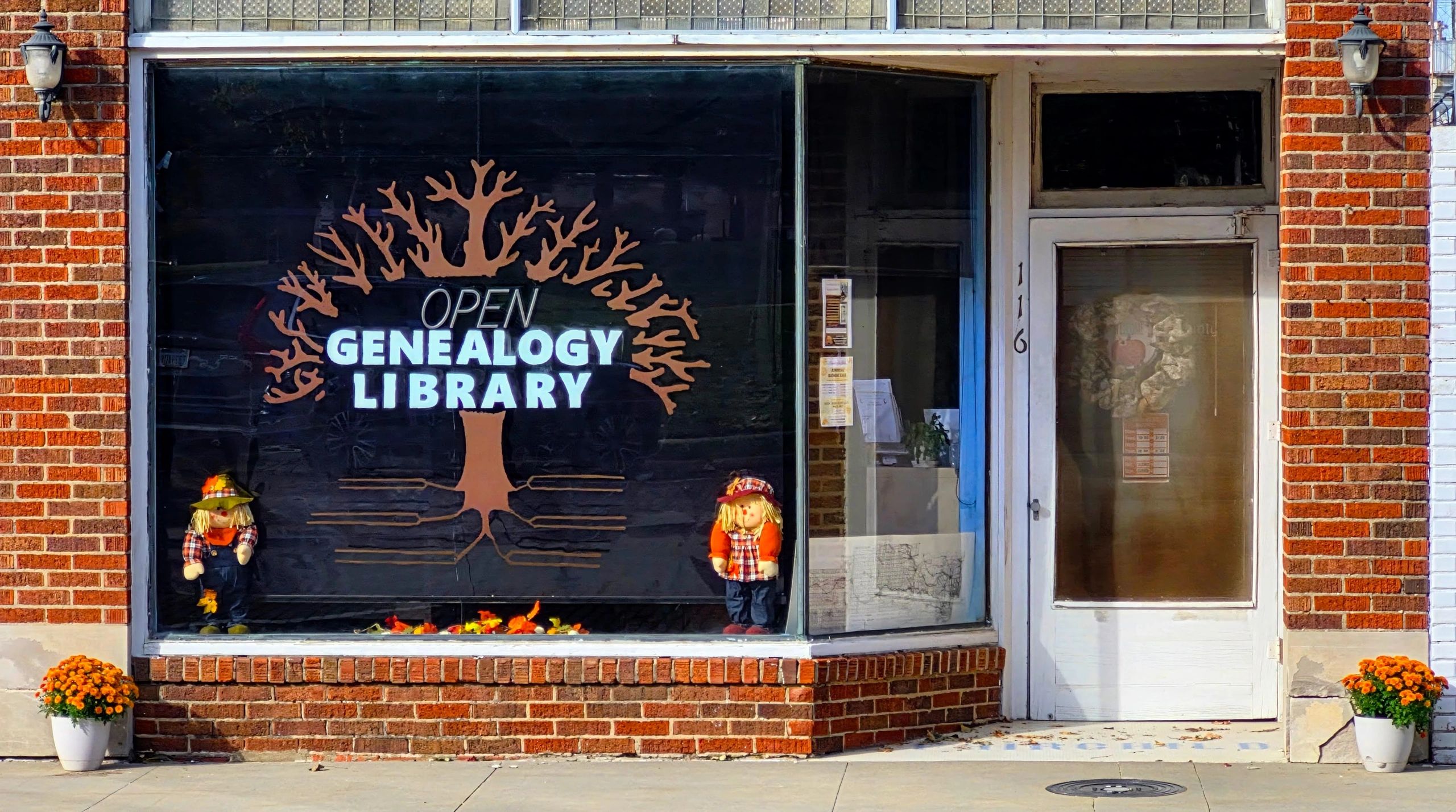 A PICTURE OF THE FRONT OF THE BUILDING THAT HAS A TREE PAINTED ON THE WINDOW