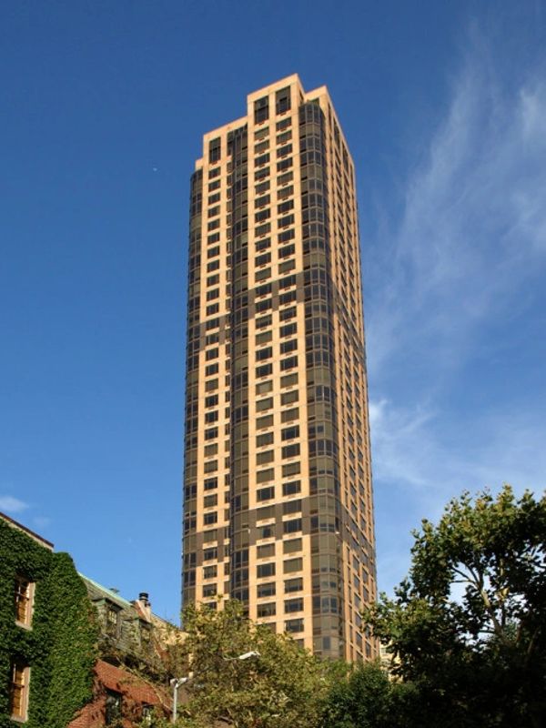 Tall modern skyscraper against a clear blue sky.