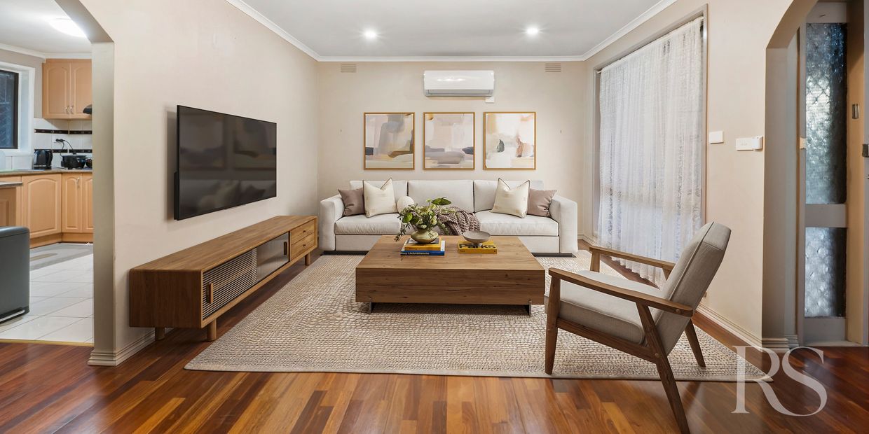 Modern living room with wooden furniture and neutral tones.
