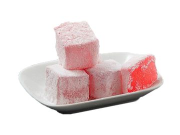 Pink Turkish delight cubes on a white plate.