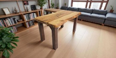 A wooden table with natural edges in a modern living room.