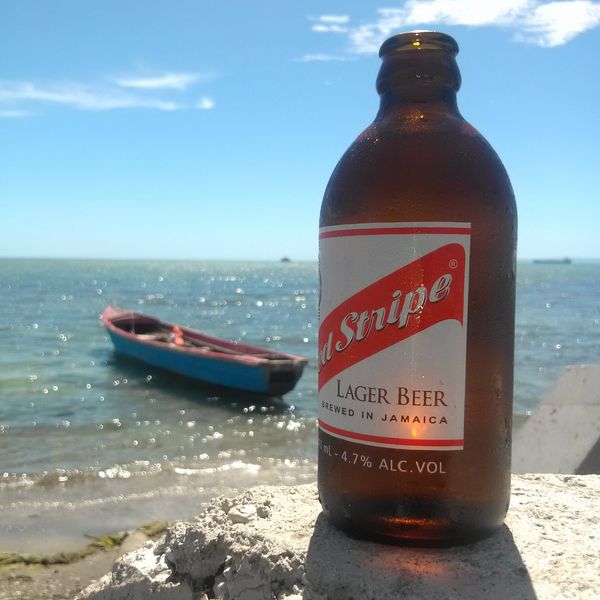 Sun, Sand, Sea, and a Cold Red Stripe Beer. The Jamaican Way.