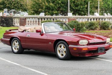 Red convertible sports car parked outdoors.