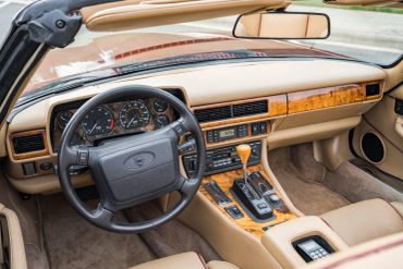 Vintage car interior with beige and wood finish.