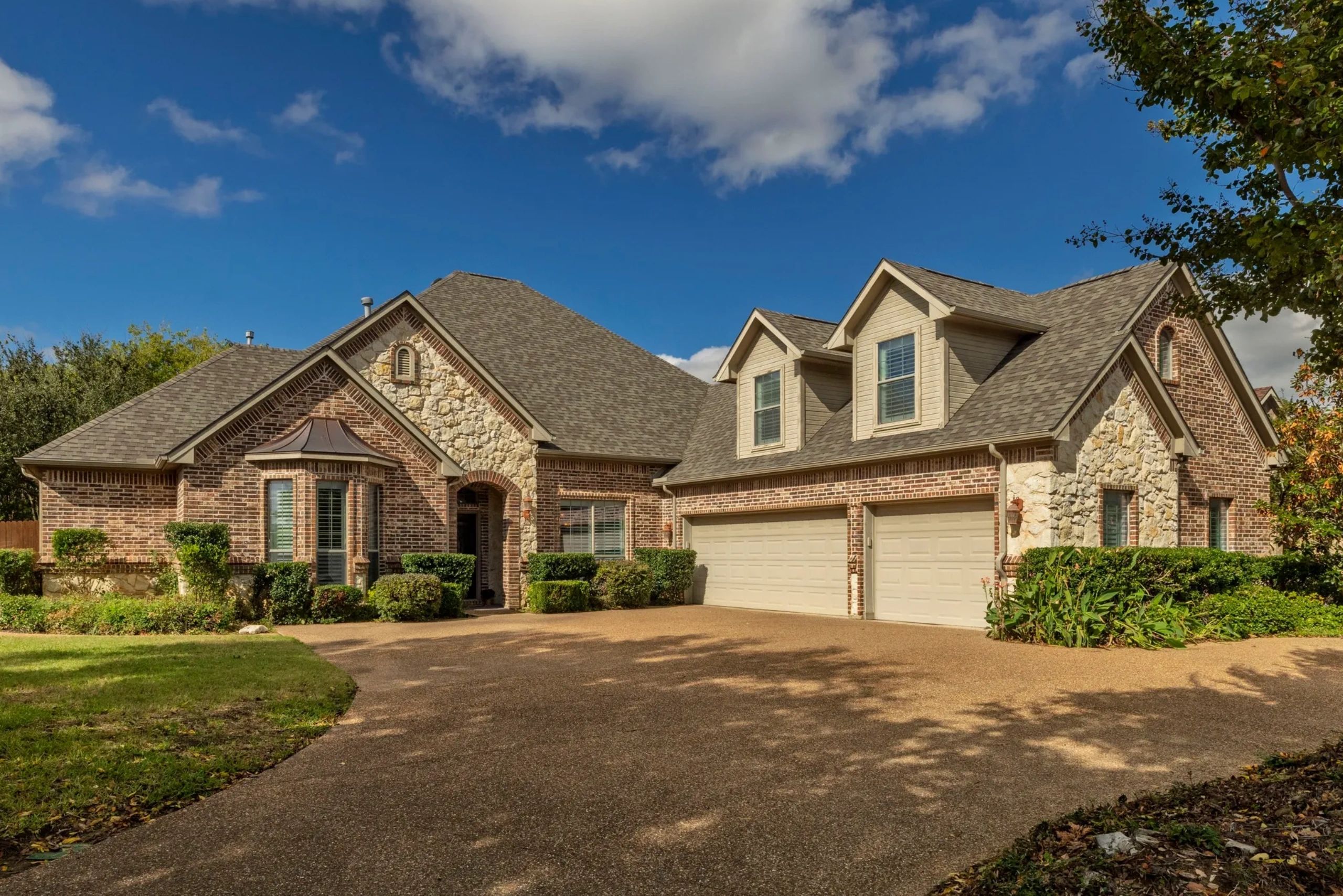 Beautiful suburban house with brick and stone exterior.
