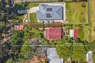 Aerial view of a residential property with a garden and house.