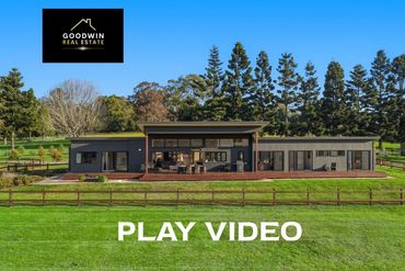 Modern real estate home with large yard and trees.