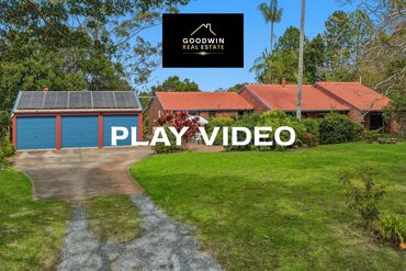 Single-story home with solar panels and a spacious yard.