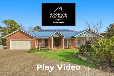 Modern brick house with solar panels and garden.
