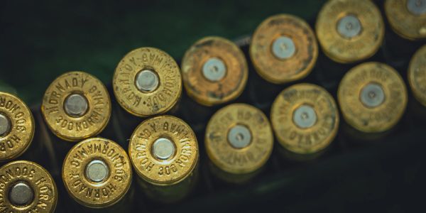 Rows of brass bullet casings lined up.