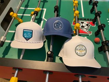 Hats with patches on a foosball table