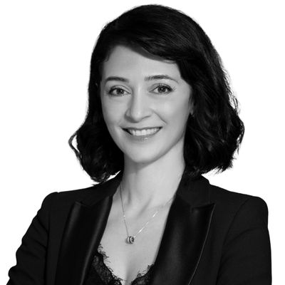 Professional woman with arms crossed, smiling.