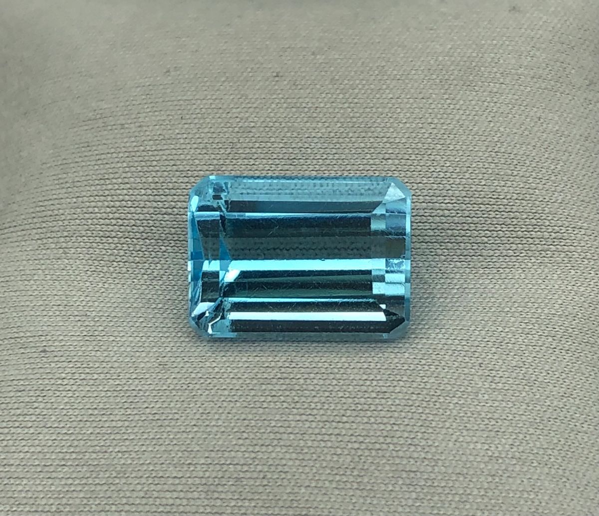 Natural Blue Topaz, 10.86 Carat Emerald Cut Faceted Gemstone.