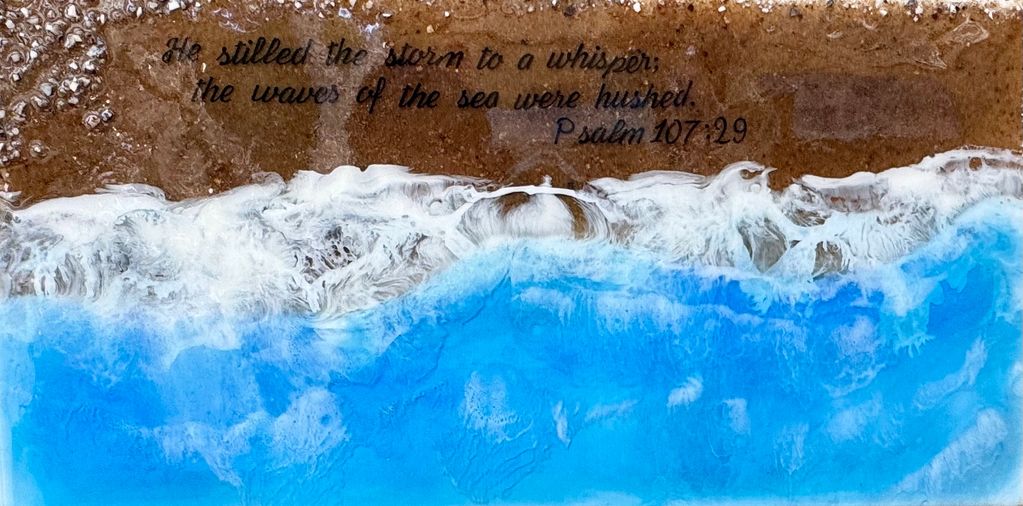 Artistic beach scene with Psalm 107:29 text overlay about calming storms and waves.