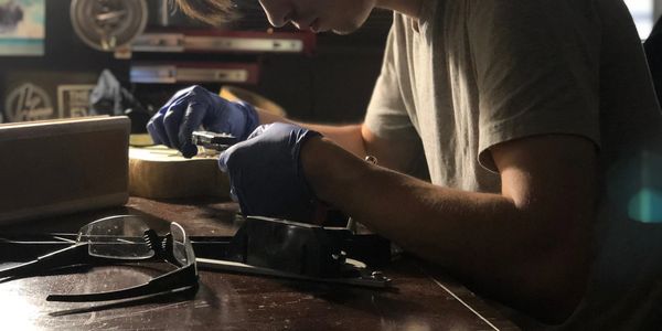 A person creating a guitar