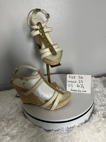 Louis Vuitton Off white leather espadrille sandals featuring a gold-tone T-strap with embossed LV mo