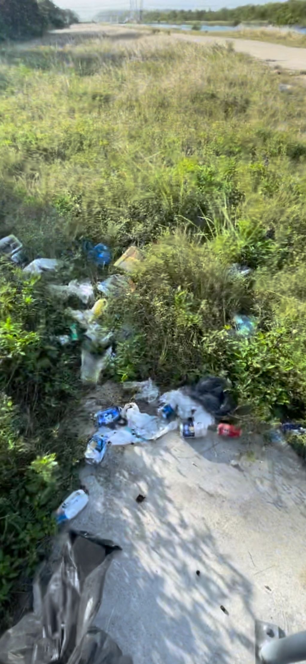 Trash overflowing from cans and scattered all over the grounds at Biscayne National Park FL 
